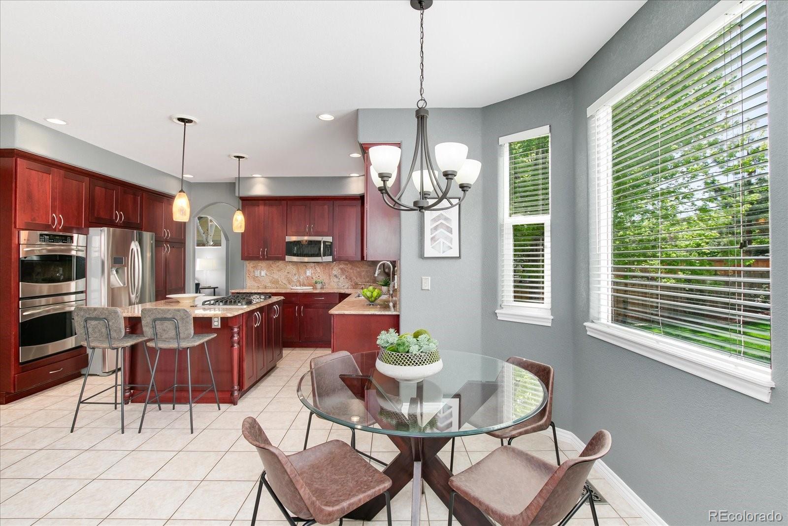 9318 Reed Way Broomfield, CO 80021 - Photo 11 of 33 a dining room filled chandelier and kitchen view