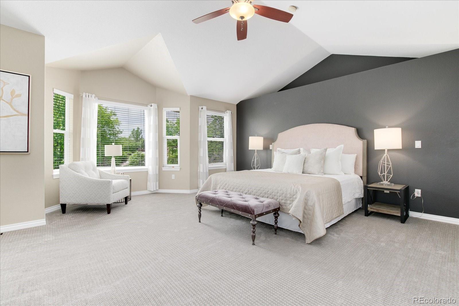 9318 Reed Way Broomfield, CO 80021 - Photo 18 of 33 a spacious bedroom with a bed and a couch