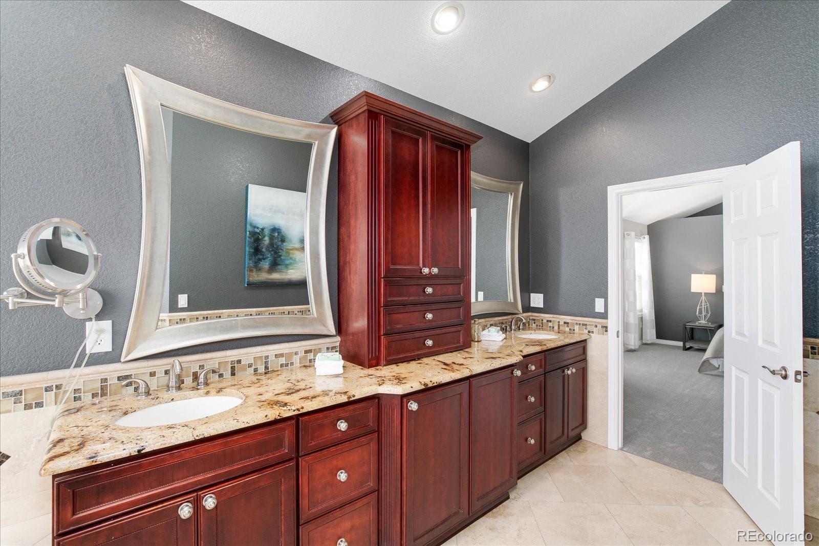 9318 Reed Way Broomfield, CO 80021 - Photo 20 of 33 a bathroom with a granite countertop sink and a mirror