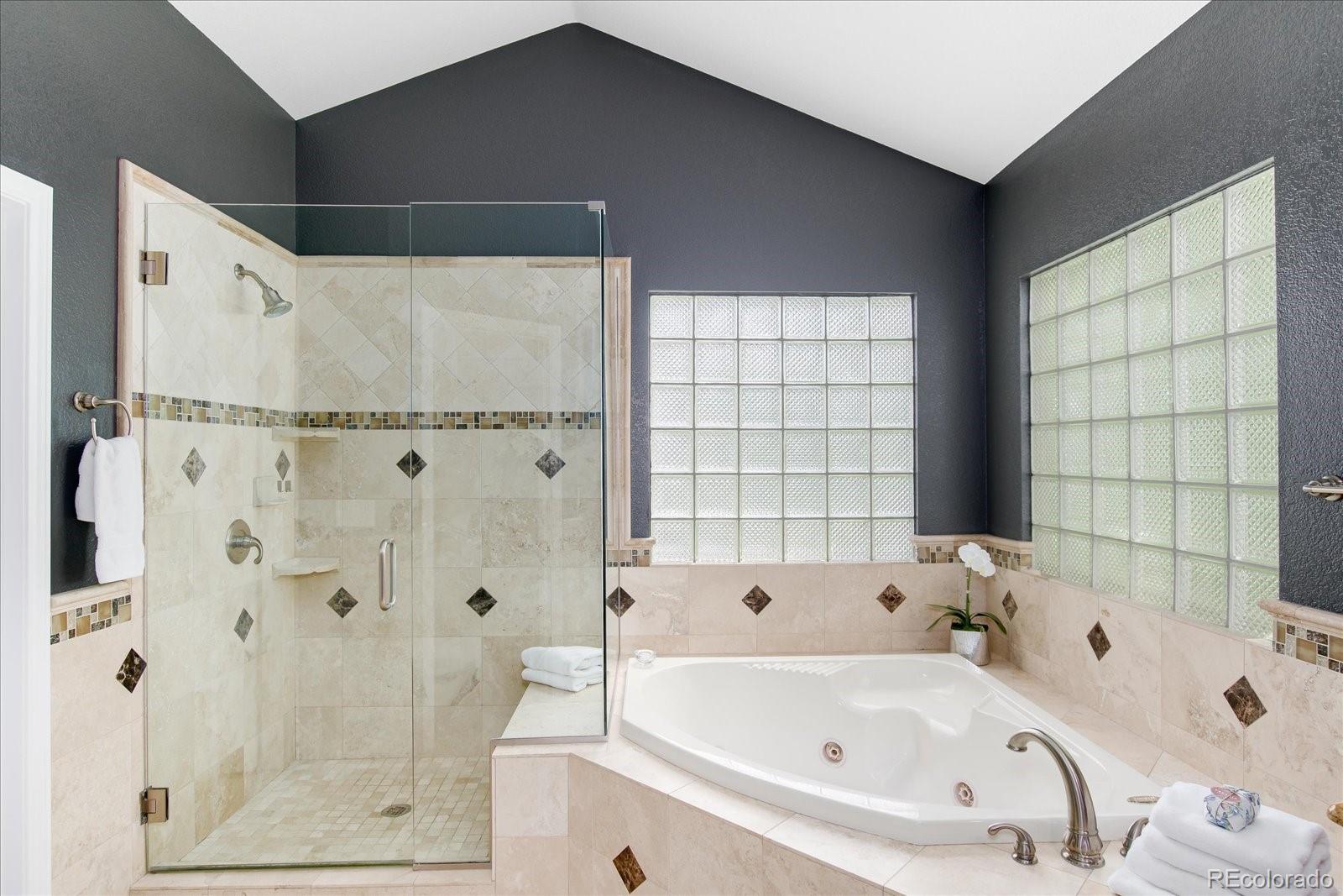 9318 Reed Way Broomfield, CO 80021 - Photo 22 of 33 a bathroom with a bathtub and shower