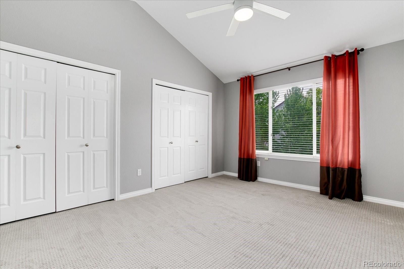 9318 Reed Way Broomfield, CO 80021 - Photo 23 of 33 an empty room with windows and a chandelier fan
