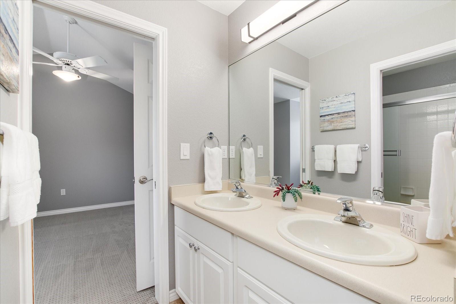 9318 Reed Way Broomfield, CO 80021 - Photo 26 of 33 a bathroom with a sink and a mirror