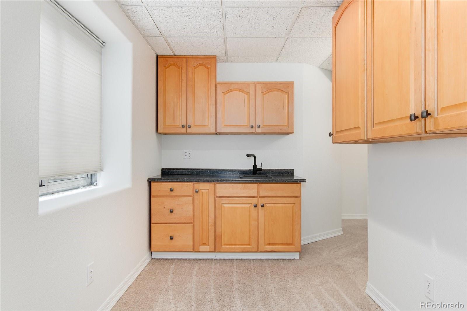 9318 Reed Way Broomfield, CO 80021 - Photo 29 of 33 a view of cabinets and wooden floor