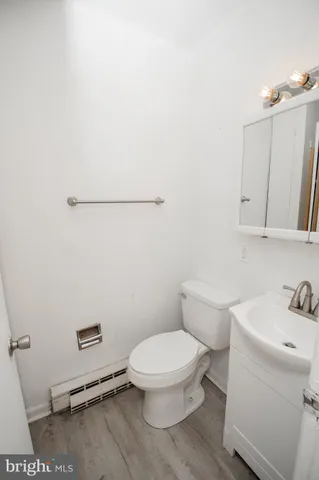 a white toilet sitting next to a bathroom sink
