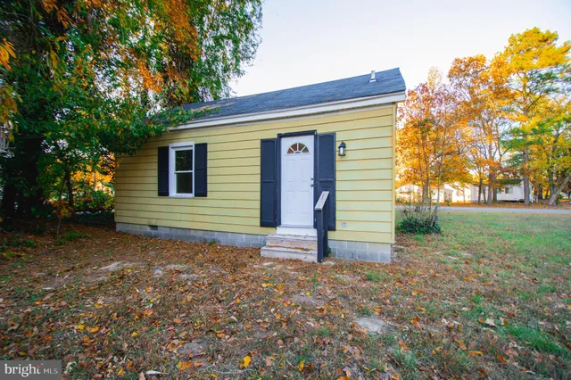 a view of a house with backyard and tree