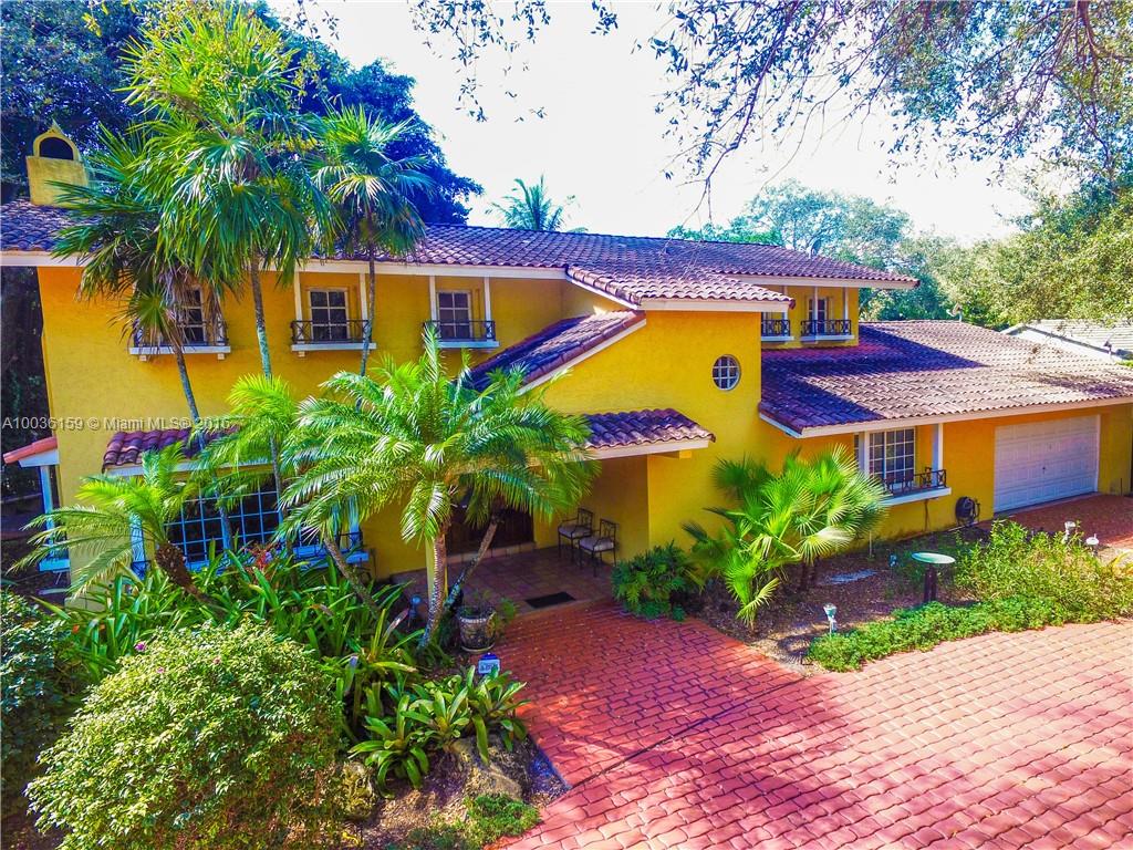 a view of a house with a yard and potted plants