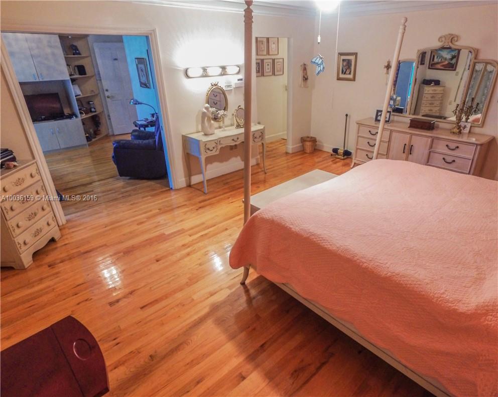 6950 Granada Boulevard Coral Gables, FL 33146 - Photo 13 of 15 a bed room with a bed and a television