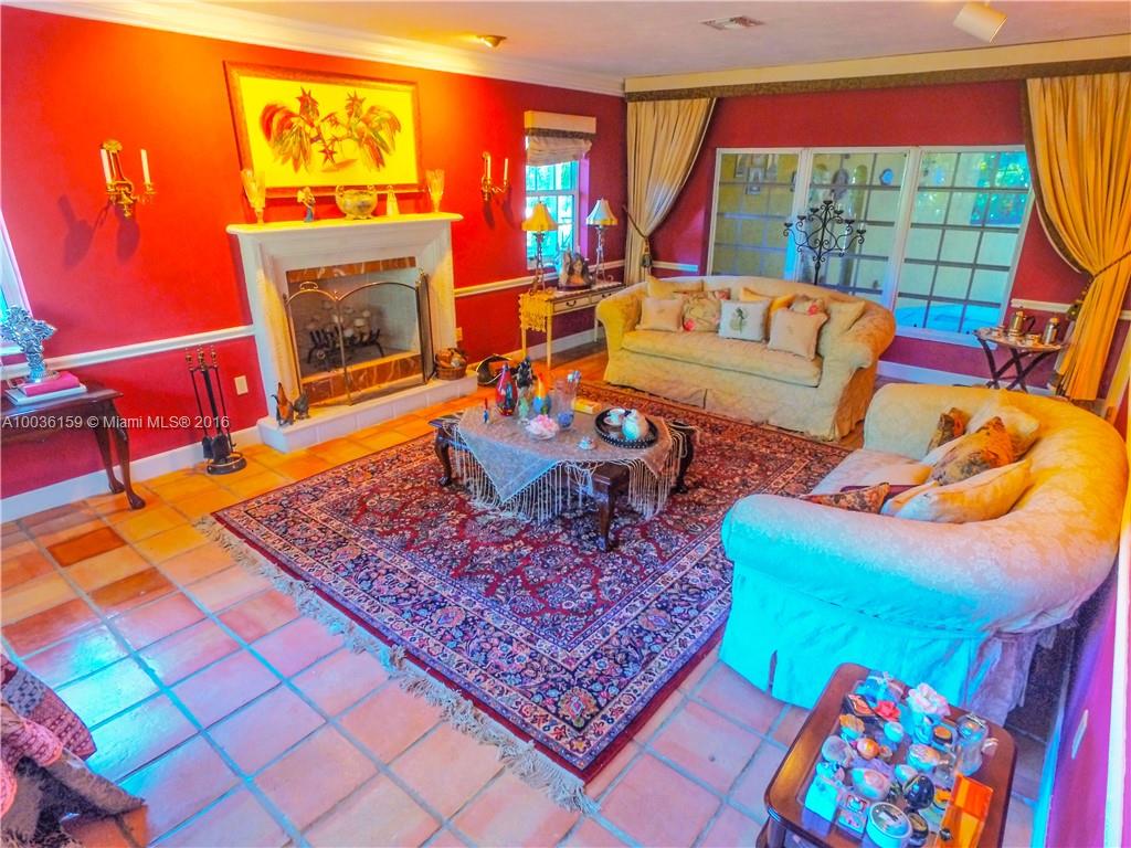 6950 Granada Boulevard Coral Gables, FL 33146 - Photo 2 of 15 a living room with patio a couch and a fireplace