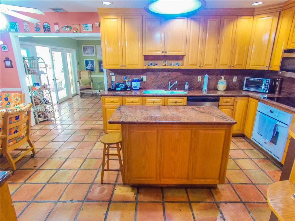 6950 Granada Boulevard Coral Gables, FL 33146 - Photo 5 of 15 a kitchen with a sink and a cabinets