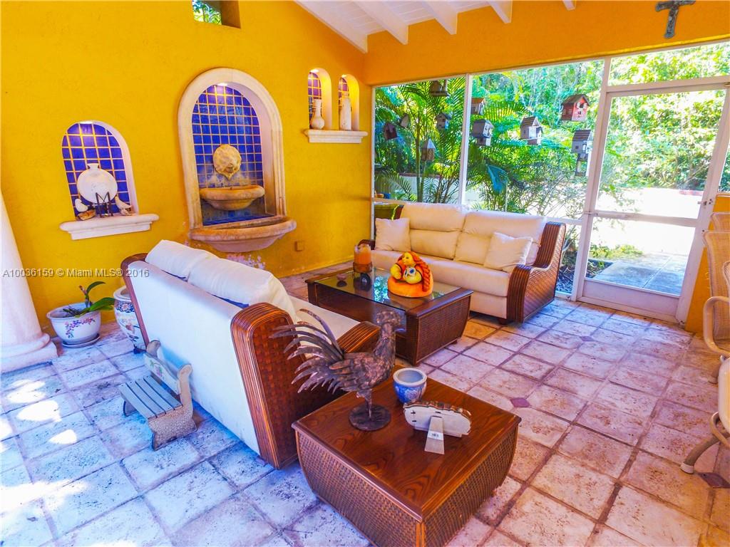 6950 Granada Boulevard Coral Gables, FL 33146 - Photo 6 of 15 a living room with patio furniture and wooden floor