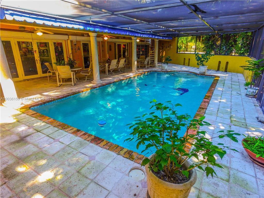6950 Granada Boulevard Coral Gables, FL 33146 - Photo 10 of 15 a swimming pool with outdoor seating