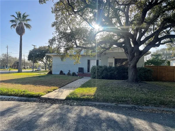 a view of a house with swimming pool yard and palm tree