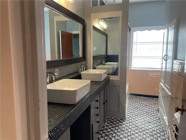 a bathroom with a sink a toilet and window