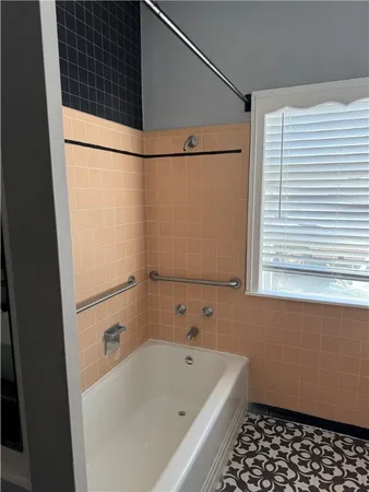 a bathroom with a bathtub and a shower