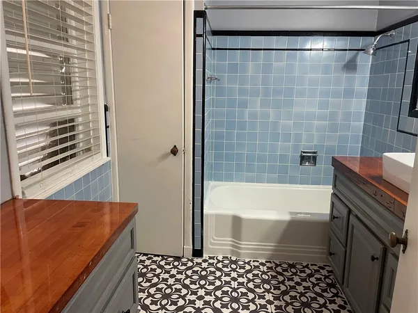 a bathroom with a bathtub and shower