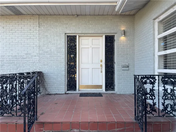 a front view of a house with many windows