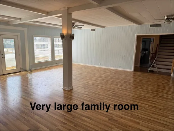 a view of a hall with wooden floor