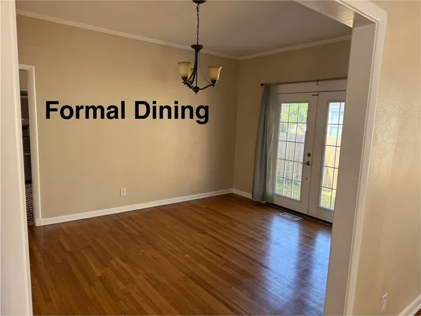 a view of a room with wooden floor and windows