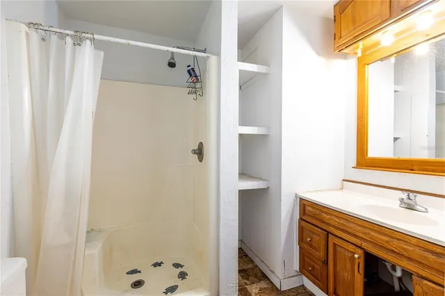 a bathroom with a double vanity sink a mirror and a shower