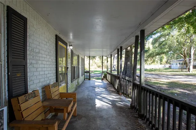a view of a porch with wooden floor and outdoor space