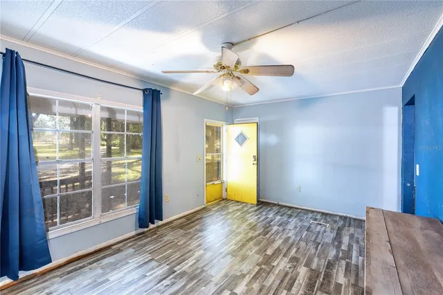 wooden floor in an empty room with a window