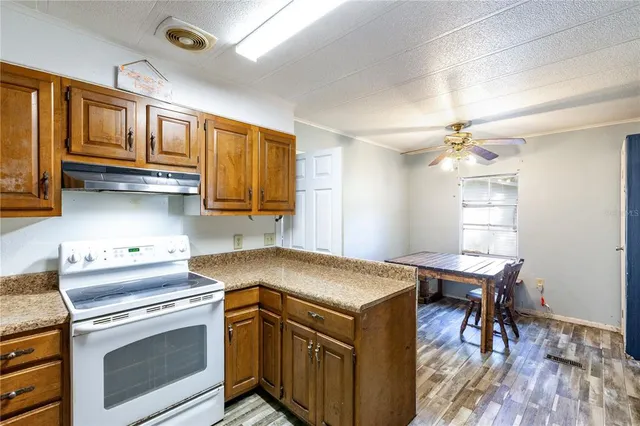 a kitchen with a stove a sink and a refrigerator