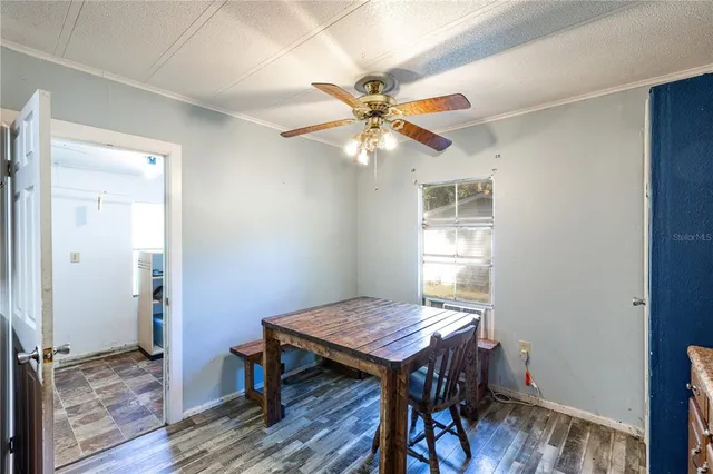 a view of a workspace with wooden floor and a chandelier fan