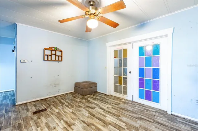 a view of empty room with wooden floor