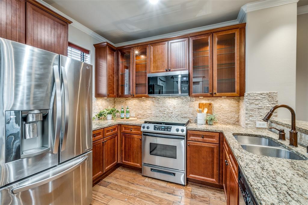 1600 Abrams Road, Unit 54 Dallas, TX 75214 - Photo 12 of 23 a kitchen with granite countertop a refrigerator stove and sink