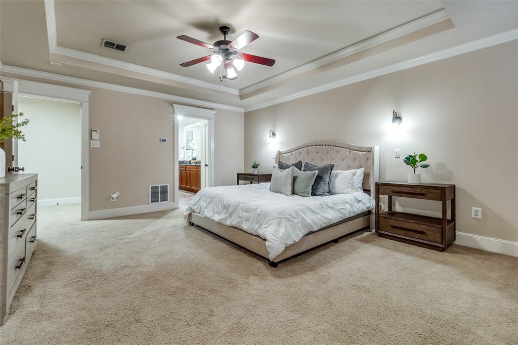 1600 Abrams Road, Unit 54 Dallas, TX 75214 - Photo 17 of 23 a bedroom with a large bed and a chandelier