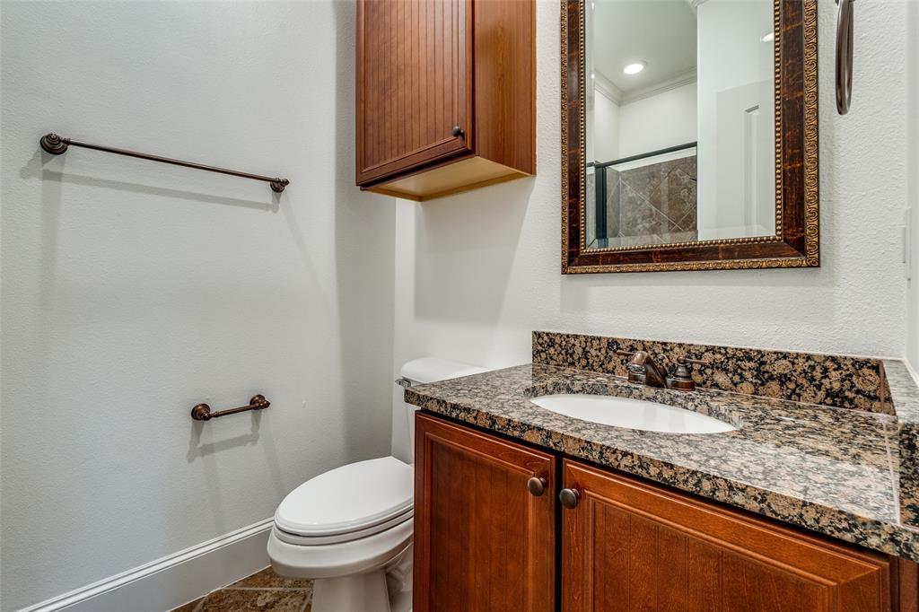 1600 Abrams Road, Unit 54 Dallas, TX 75214 - Photo 22 of 23 a bathroom with a granite countertop sink a toilet a mirror and shower