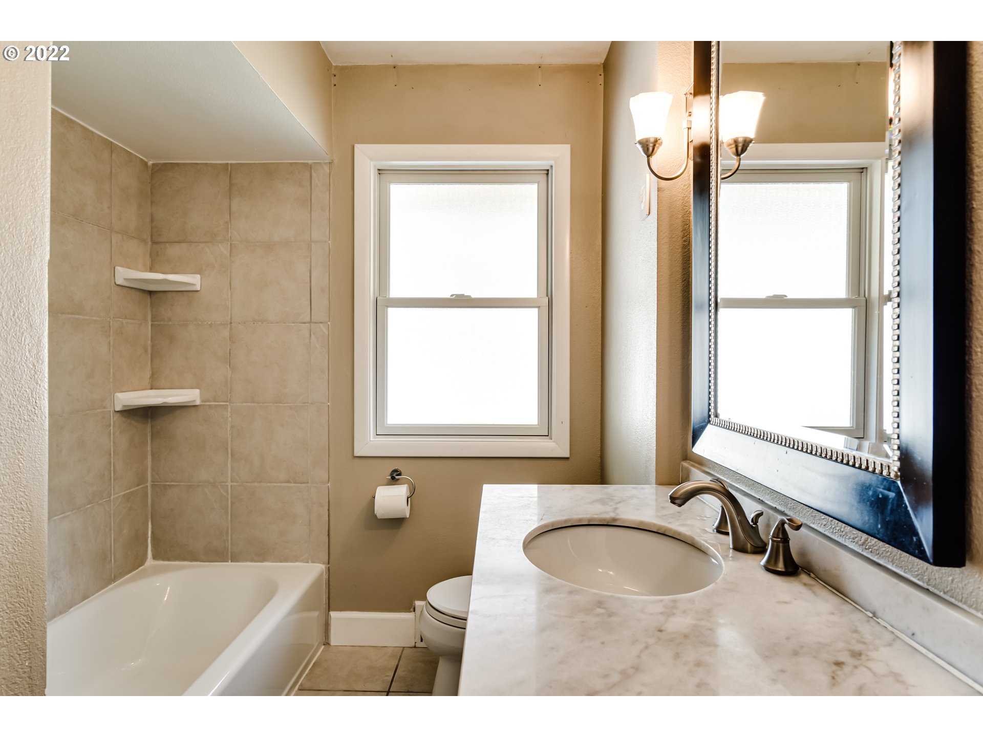 595 Dartmoor Drive Eugene, OR 97401 - Photo 20 of 32 a bathroom with a sink toilet a mirror and next to a window