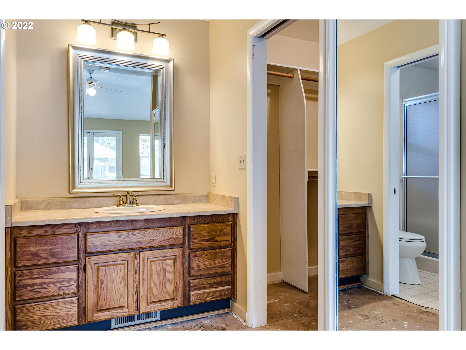 595 Dartmoor Drive Eugene, OR 97401 - Photo 24 of 32 a bathroom with a granite countertop sink a toilet and a mirror