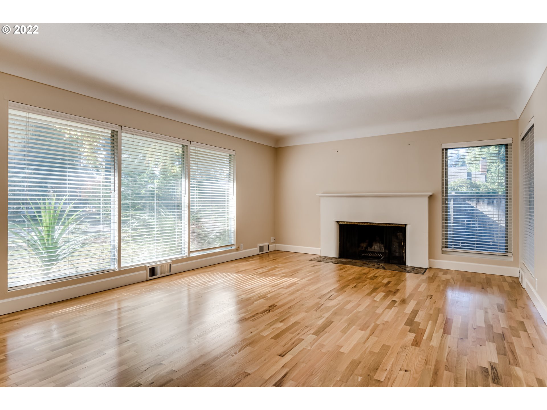 595 Dartmoor Drive Eugene, OR 97401 - Photo 5 of 32 a view of empty room with wooden floor and fireplace