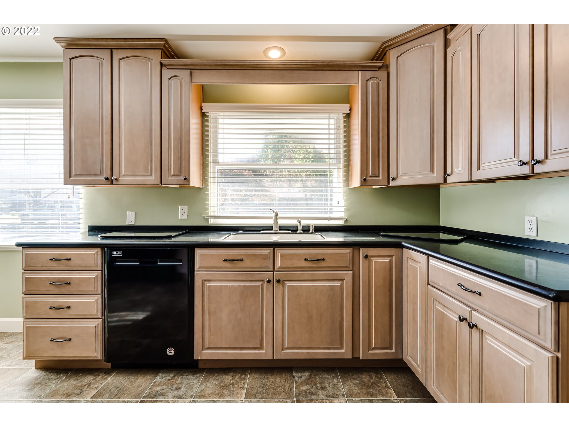 595 Dartmoor Drive Eugene, OR 97401 - Photo 8 of 32 a kitchen with granite countertop a sink cabinets and a window