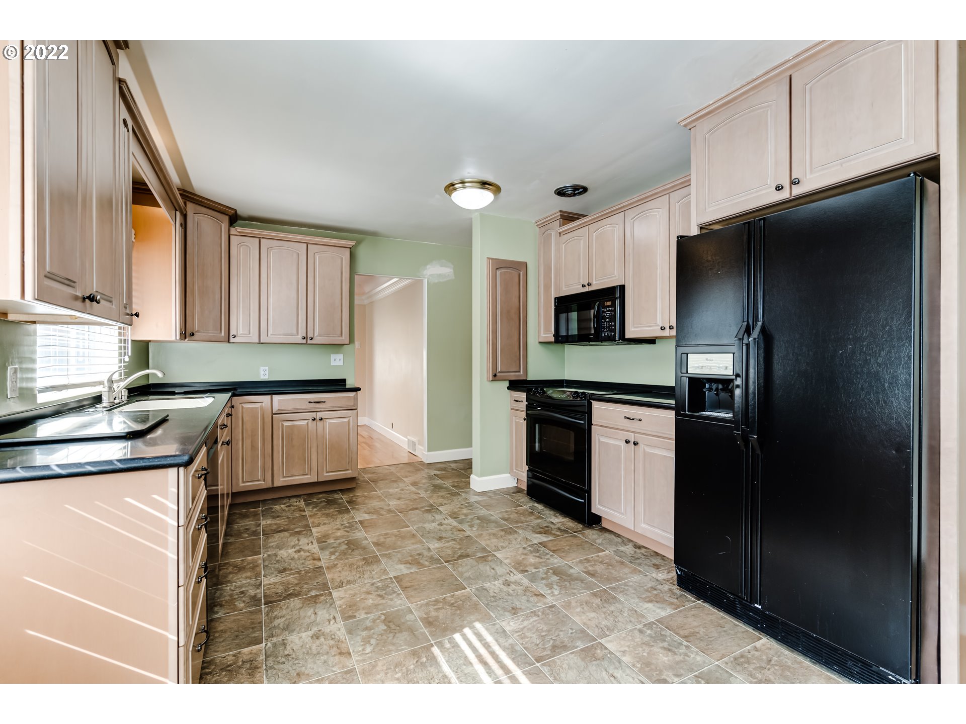 595 Dartmoor Drive Eugene, OR 97401 - Photo 9 of 32 a kitchen with granite countertop a refrigerator stove and sink
