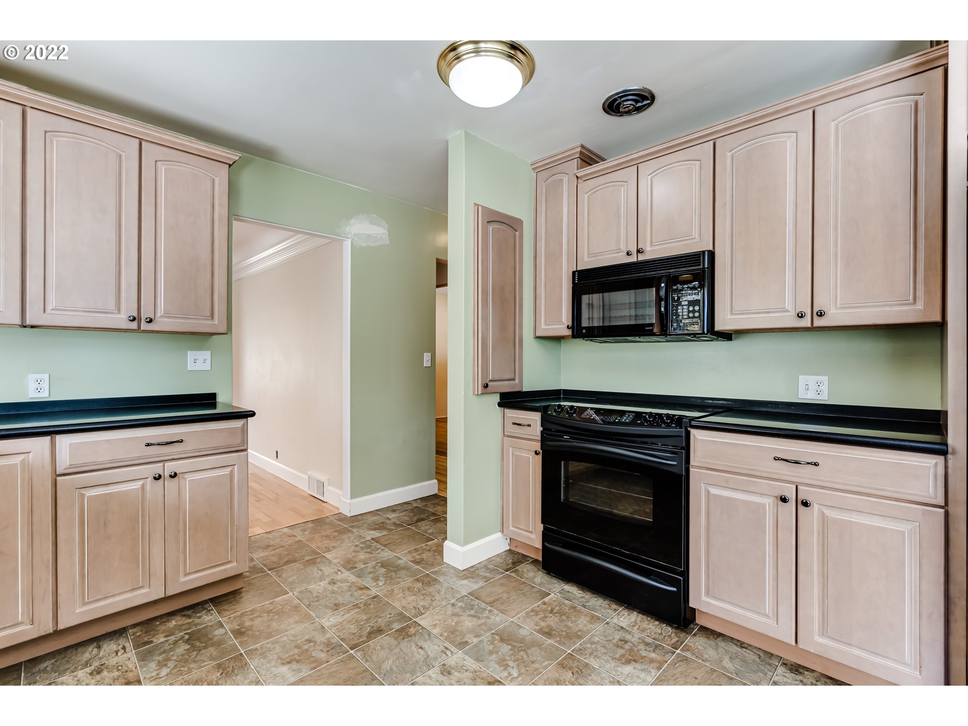 595 Dartmoor Drive Eugene, OR 97401 - Photo 10 of 32 a kitchen with stainless steel appliances granite countertop a stove a sink and a microwave