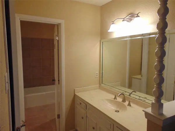 a bathroom with a shower sink and mirror