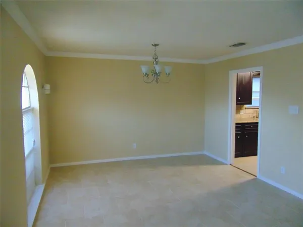 an empty room with windows and cabinet
