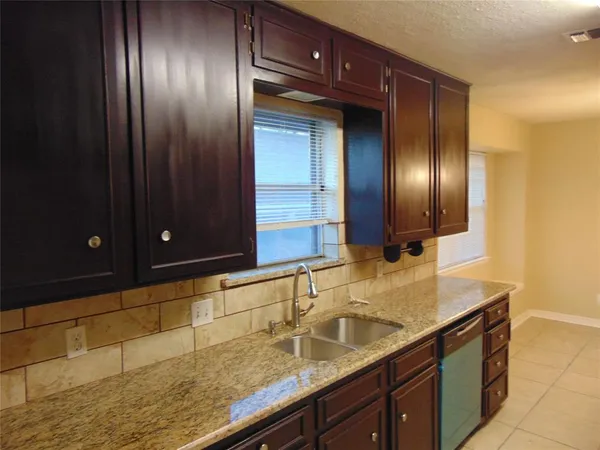 a bathroom with double vanity and a mirror