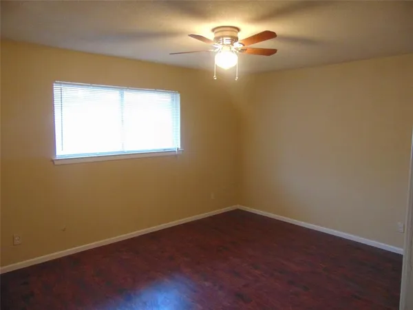 a view of a room with a window and wooden floor