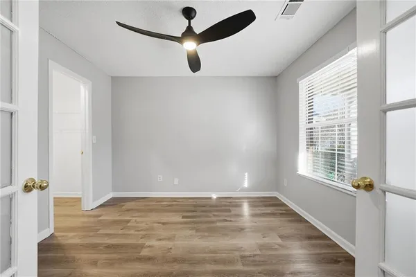 wooden floor in an empty room with a window