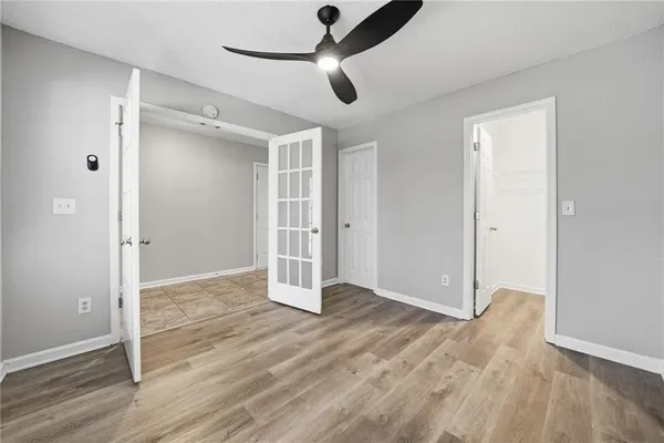 a view of an empty room with wooden floor