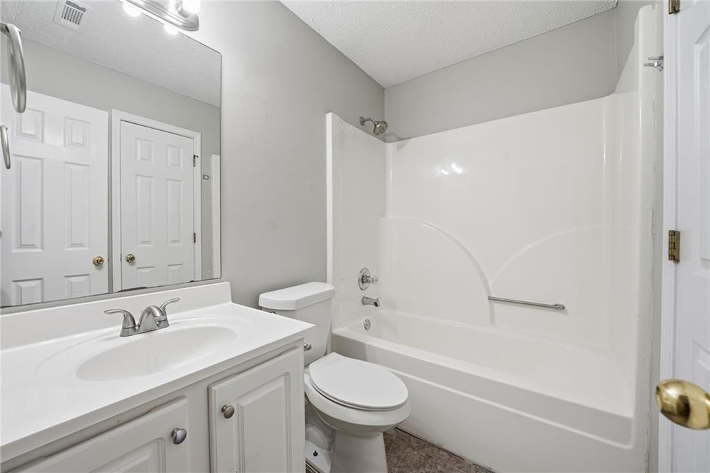 2297 Charleston Pointe Southeast Atlanta, GA 30316 - Photo 14 of 48 a bathroom with a sink toilet and shower