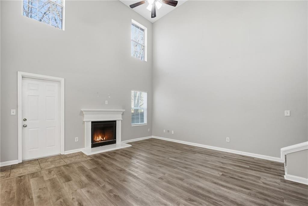 2297 Charleston Pointe Southeast Atlanta, GA 30316 - Photo 21 of 48 a view of an empty room with wooden floor fireplace and a window