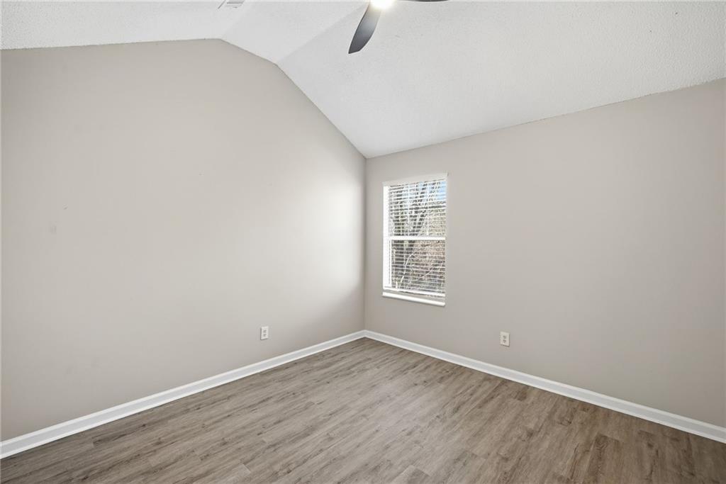 2297 Charleston Pointe Southeast Atlanta, GA 30316 - Photo 23 of 48 an empty room with wooden floor and windows
