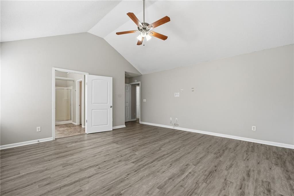 2297 Charleston Pointe Southeast Atlanta, GA 30316 - Photo 28 of 48 an empty room with wooden floor and ceiling fan
