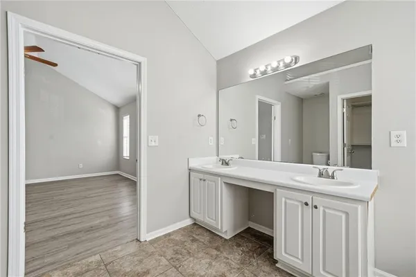 a bathroom with a double vanity sink and a mirror