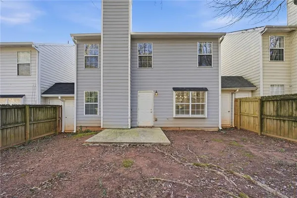 a view of house with backyard and parking