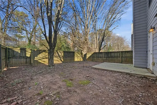 a view of a backyard with large trees